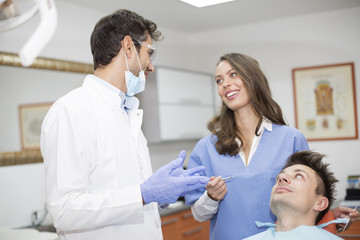 Young man having dental chekup at dentist office