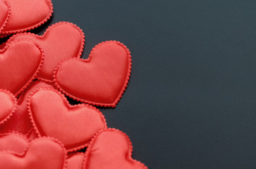 Valentine's Day Background/Theme. Red Hearts On A Black Background. Free Space For Text. Close-Up. Angle View.