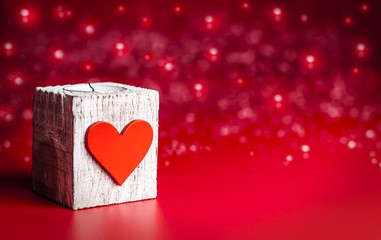 decorative candle with a heart on a red background