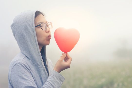 Asian woman holding red heart