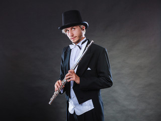 Elegantly dressed musician holding flute