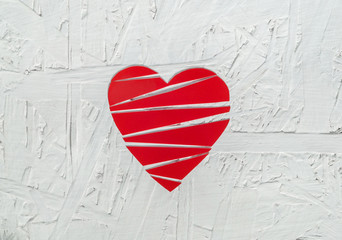 Paper broken heart on white wooden background