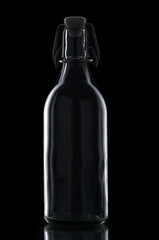 Vintage glass bottle on black background