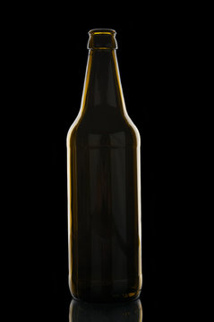 Empty beer bottle on black background