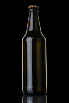 Beer bottle with cork on black background