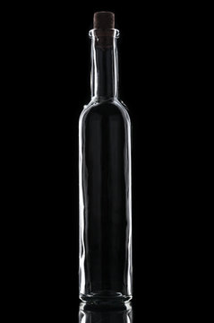 Empty vintage bottle with cork  on black background