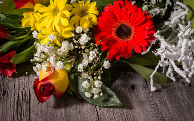 Bouquet of flowers on wooden background