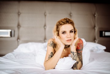 Beautiful bride with tattoo at wedding morning