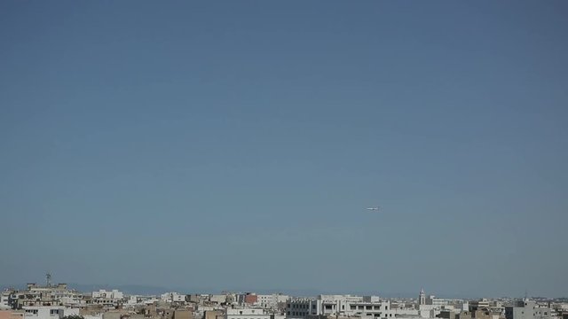 Plane over the city 
Shooting plane flying over the city of Tunis
