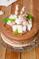 Marble chocolate coffee cheesecake with meringue, marshmallow and chocolate on top