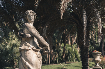 old sculpture of a woman in the park