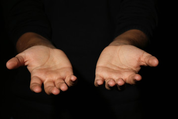 Male hands on a black background