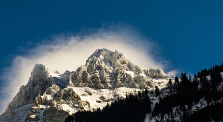 Mountain peak with a halo of cloud cover
