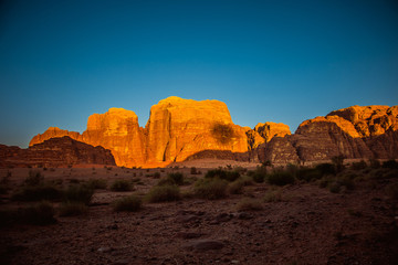Amazing sunset on red rock in desert of Wadi Rum. Petra. Jordan