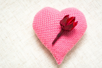 Knitted heart with dried flowers on a linen napkin