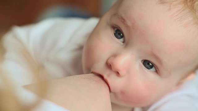 Mother with blond hair breastfeeding