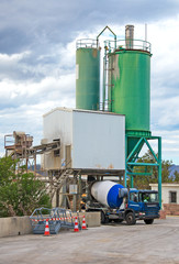 The heavy truck is loading on cement factory.