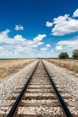 Rail Road and Clouds in a blue Sky in New Mexico