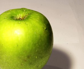 Big juicy green Apple on grey background