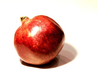 Big juicy red pomegranate on a white background