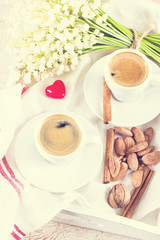 espresso, nuts and bouquet of flowers