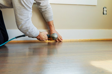 Gauge Finish Nailer man nailed slats custom house building contractor up a wall section for luxury