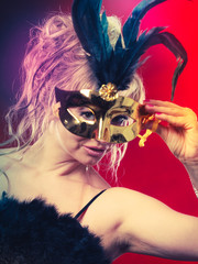 Attractive woman wearing carnival mask.