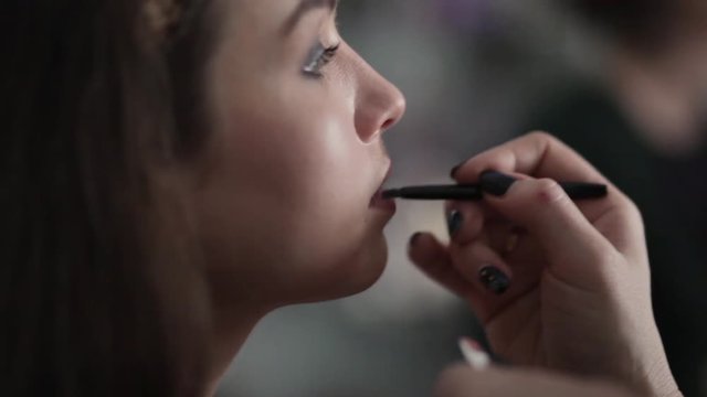make-up artist working with model