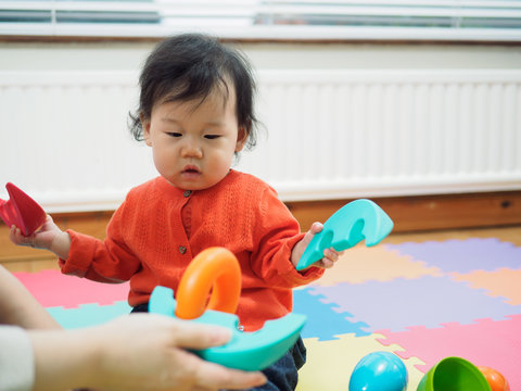 Asian baby playing building blocks toys