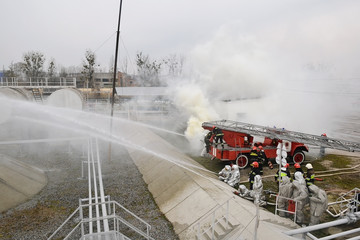 people  in suit of protection against fire