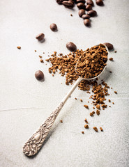 Spoon with instant coffee and coffee beans, retro style toned, copy space.