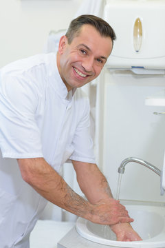 Portrait of doctor washing hands