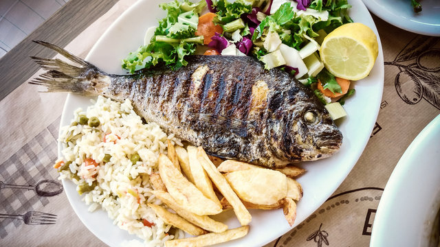 Bream with potato, rice and salad