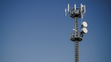 Communication tower against crystal clear blue sky background