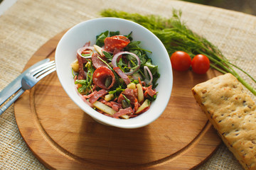salad in white bowl on a background of nature
