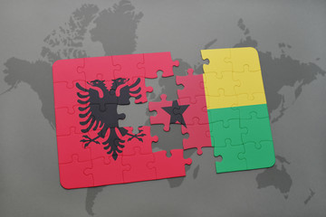 puzzle with the national flag of albania and guinea bissau on a world map