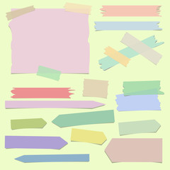 Multiple pieces of colorful sticky tape in different shapes on light yellow background - 134525694