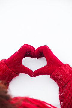 Heart Sign On Snow Hands In Red Gloves