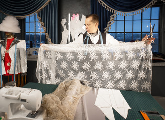 Tailor measures the fabric in the studio