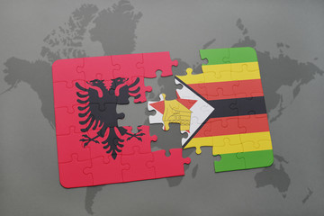 puzzle with the national flag of albania and zimbabwe on a world map