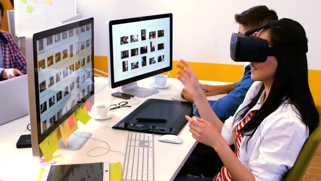Graphic designers using virtual reality headset in office 4k