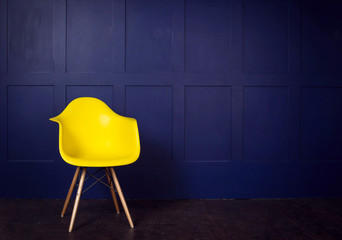 Interior design scene with yellow chair on blue wall