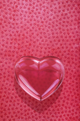 glass love heart on red background