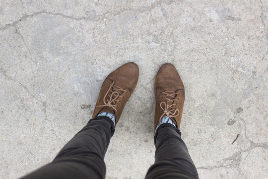 Two Feet In Brown Shoes Over Concret, First Person View