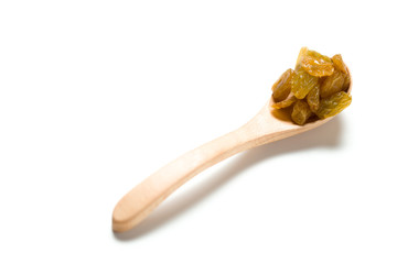 A dried raisin in a wooden spoon isolated over white background