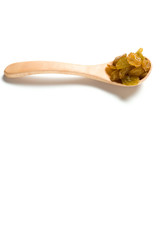 A driend raisin in a wooden spoon isolated over white background