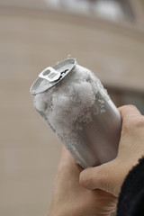 Hands holding a beer can