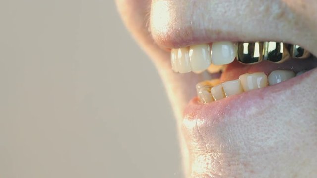 Mouth of old woman aged 80s with false teeth. Close up