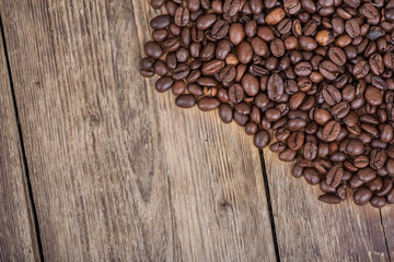 Coffee beans on wooden background. Top view.
