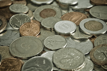 Coins of several currencies - background pattern. Close up picture taken in studio.